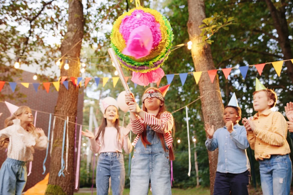 Kids enjoying a fun birthday party with colorful balloons, cake, and entertainment activities in Delhi NCR