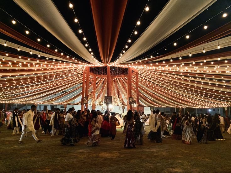 Beautiful Navratri theme decoration with Garba dance floor, colorful stage décor, Dandiya setup, carnival games, LED lighting, and families enjoying community celebrations organized by Party Events.