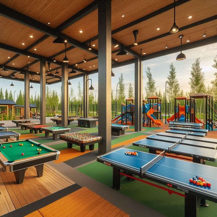 Employees participating in corporate team building games including Human Foosball, Giant Jenga, Tug of War, inflatable obstacle course, and carnival games by Party Events.
